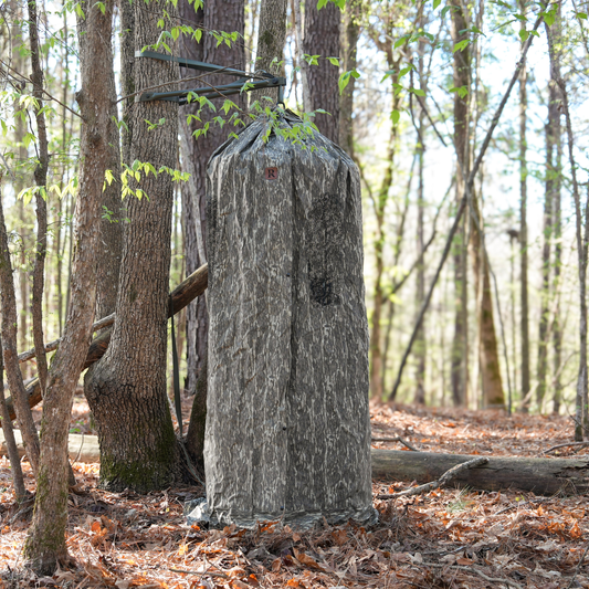 Revolve Outdoors T-Series Cordura camo hunting blind mounted to a tree in a hardwood forest